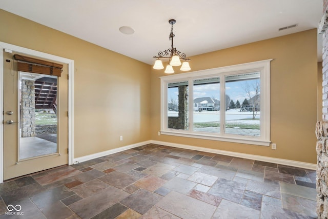 unfurnished dining area with a notable chandelier