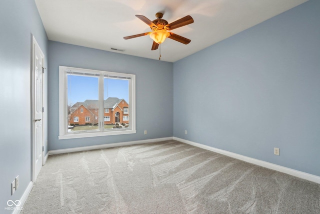 carpeted empty room featuring ceiling fan