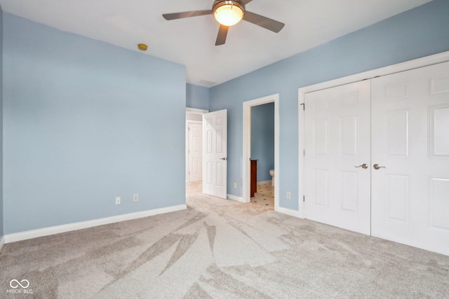 unfurnished bedroom featuring connected bathroom, light colored carpet, ceiling fan, and a closet