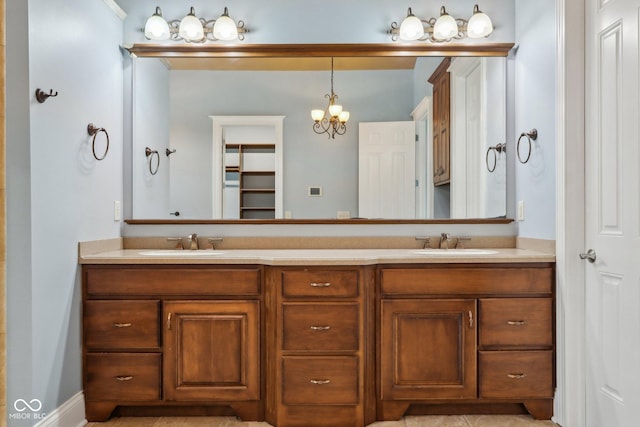 bathroom with vanity and a notable chandelier