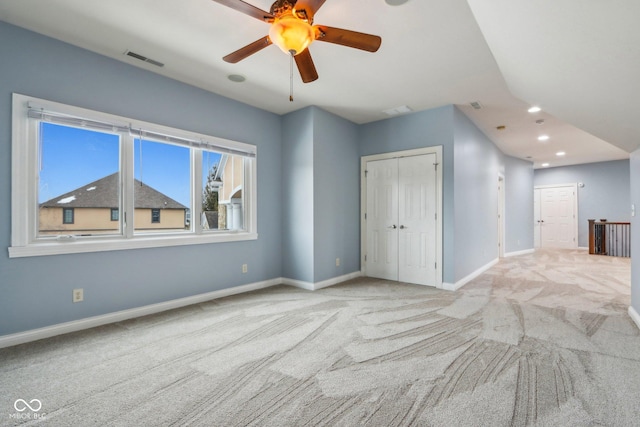 unfurnished bedroom with ceiling fan and light colored carpet