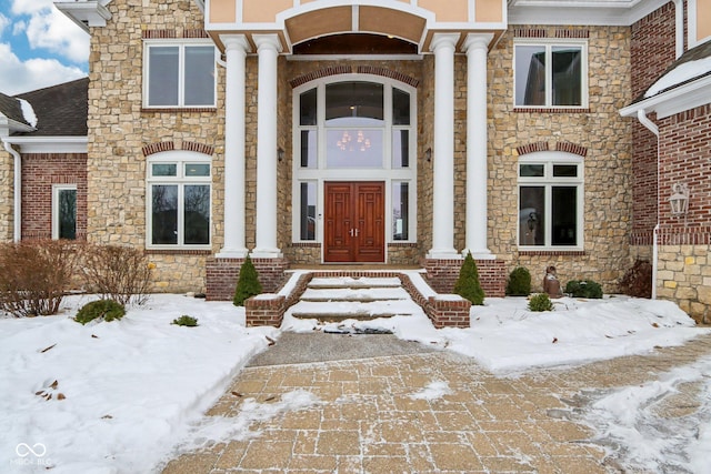 view of snow covered property entrance