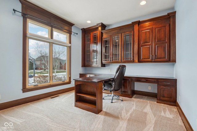 office area featuring light carpet and built in desk