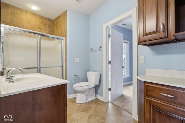 bathroom with tile patterned flooring, vanity, walk in shower, and toilet