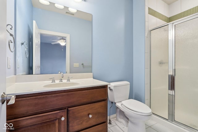 bathroom with vanity, toilet, an enclosed shower, and tile patterned flooring