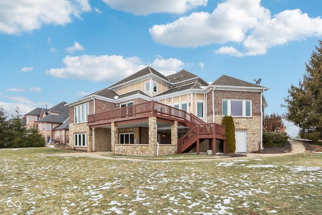 rear view of house featuring a yard and a deck