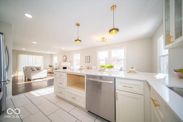 kitchen featuring decorative light fixtures, white cabinetry, light tile patterned floors, and appliances with stainless steel finishes