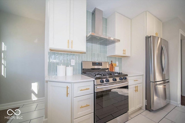 kitchen with stainless steel appliances, wall chimney range hood, light tile patterned floors, tasteful backsplash, and white cabinetry