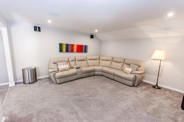 carpeted living room featuring lofted ceiling