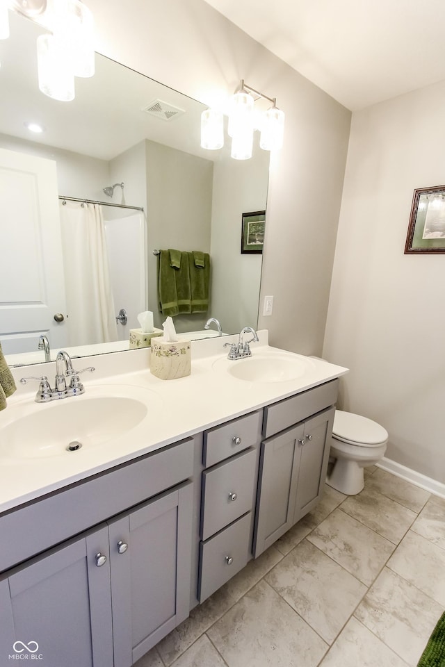 bathroom featuring walk in shower, vanity, and toilet