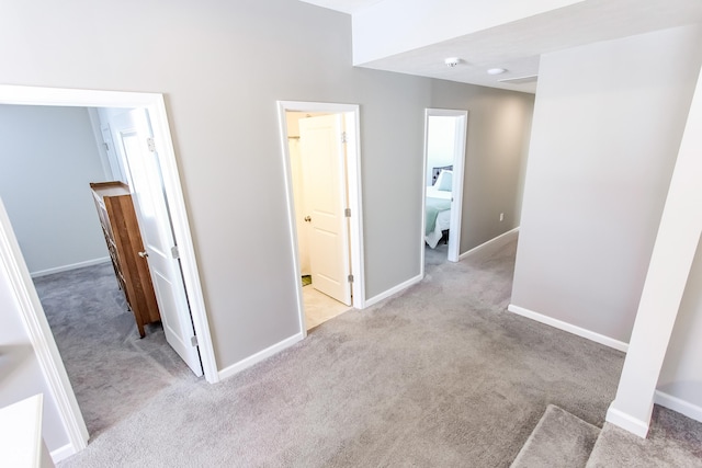 hall featuring light colored carpet