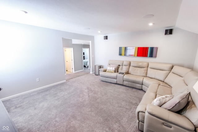 carpeted living room with vaulted ceiling