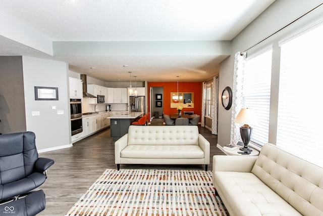 living room with hardwood / wood-style floors and a chandelier