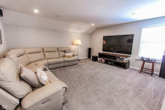 living room featuring lofted ceiling and carpet flooring