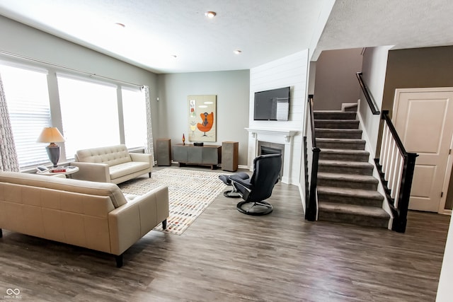 living room with dark wood-type flooring and a textured ceiling