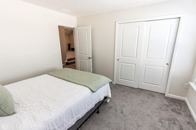 carpeted bedroom featuring a closet