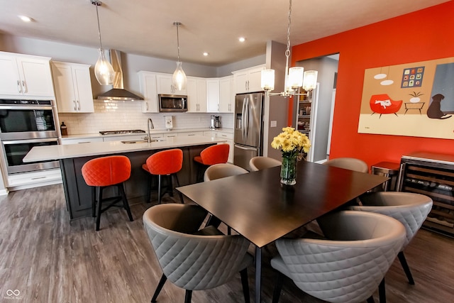 dining room featuring dark wood-type flooring, sink, and beverage cooler