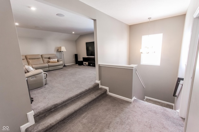 stairway featuring an inviting chandelier and carpet flooring