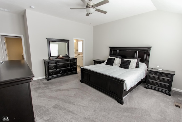 carpeted bedroom featuring ceiling fan, lofted ceiling, and connected bathroom