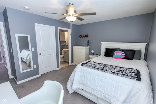 carpeted bedroom featuring ceiling fan and ensuite bath