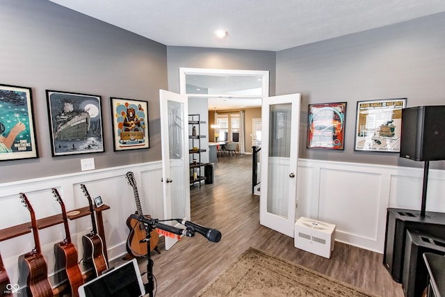 workout room featuring hardwood / wood-style floors and french doors