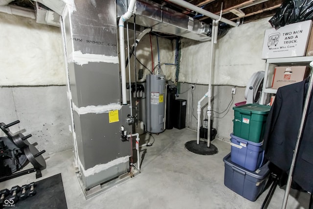 utility room with heating unit and water heater