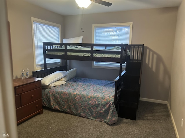 bedroom with ceiling fan, multiple windows, and carpet