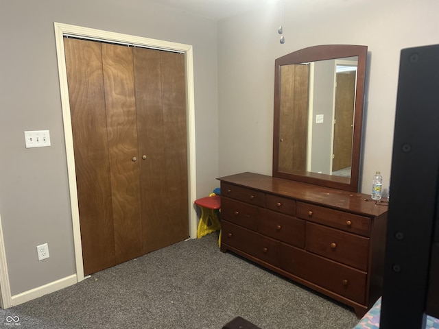 bedroom featuring a closet and dark carpet