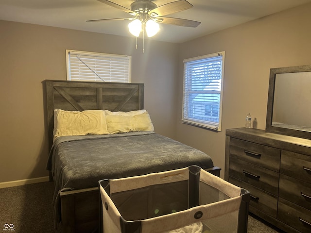 bedroom with ceiling fan and dark carpet