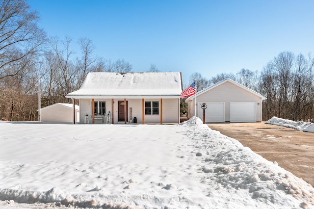 ranch-style home featuring a garage, an outbuilding, and covered porch