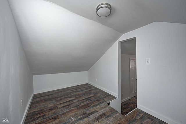 additional living space with lofted ceiling and dark hardwood / wood-style floors