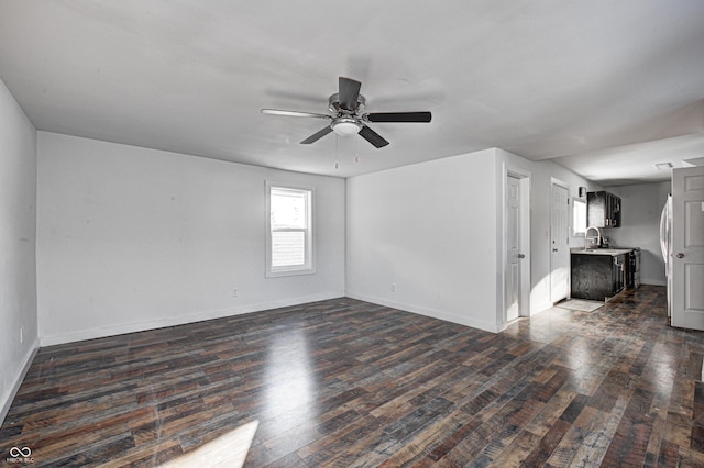 empty room with dark wood-type flooring, sink, and ceiling fan