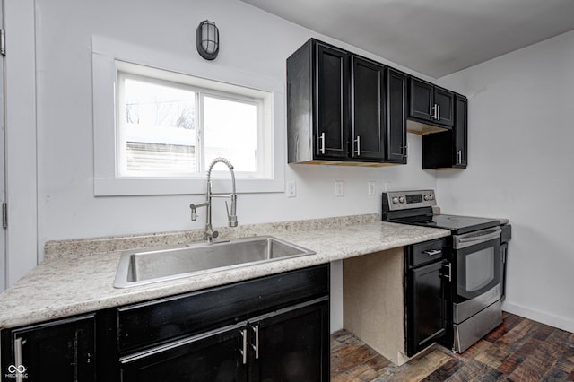 kitchen featuring dark hardwood / wood-style floors, sink, and stainless steel range with electric stovetop