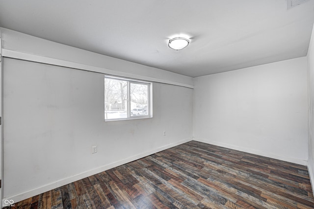 empty room with dark hardwood / wood-style floors