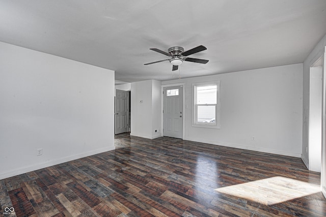 empty room featuring dark wood-type flooring and ceiling fan