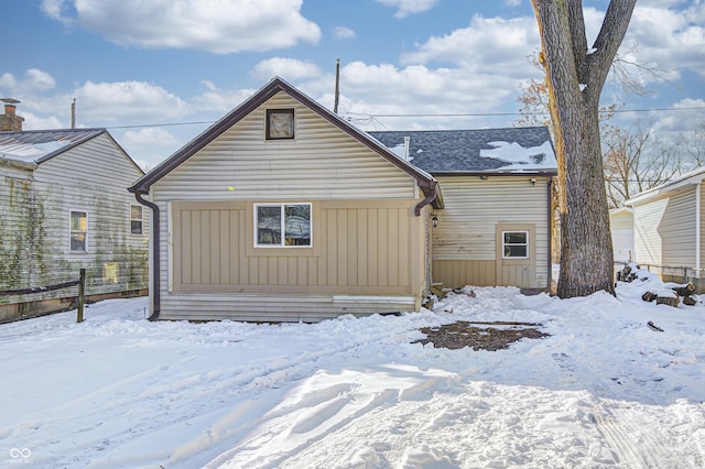 view of snow covered rear of property