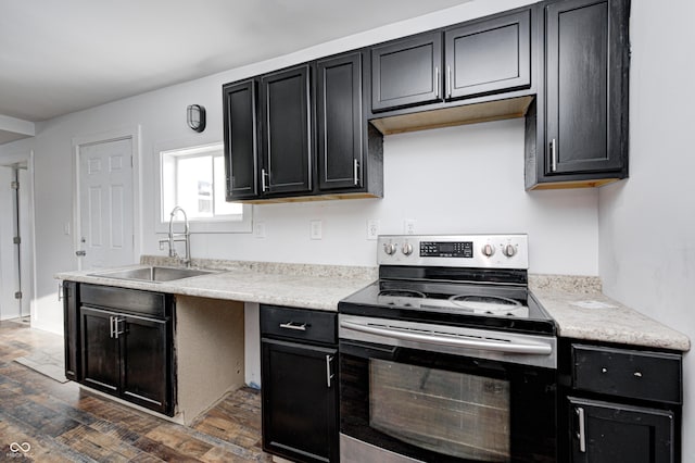 kitchen featuring dark wood-type flooring, sink, and stainless steel electric range oven