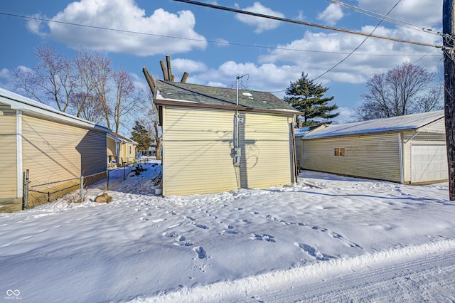 snow covered structure featuring a garage