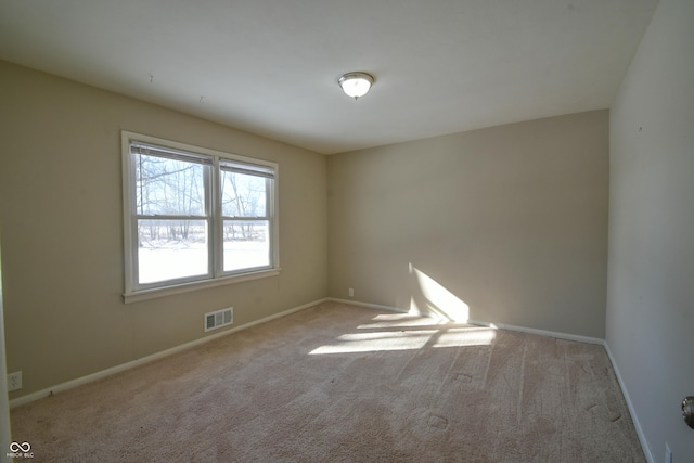 spare room with light carpet