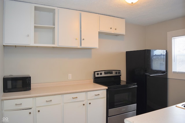 kitchen with a textured ceiling, black appliances, and white cabinetry