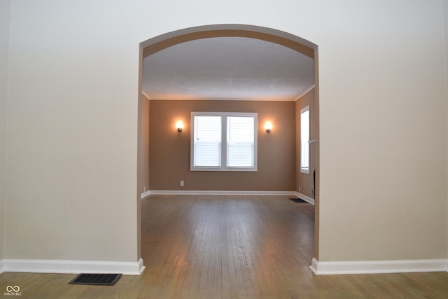 spare room featuring ornamental molding and hardwood / wood-style floors