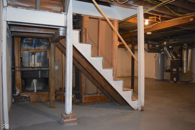 basement featuring water heater and heating unit