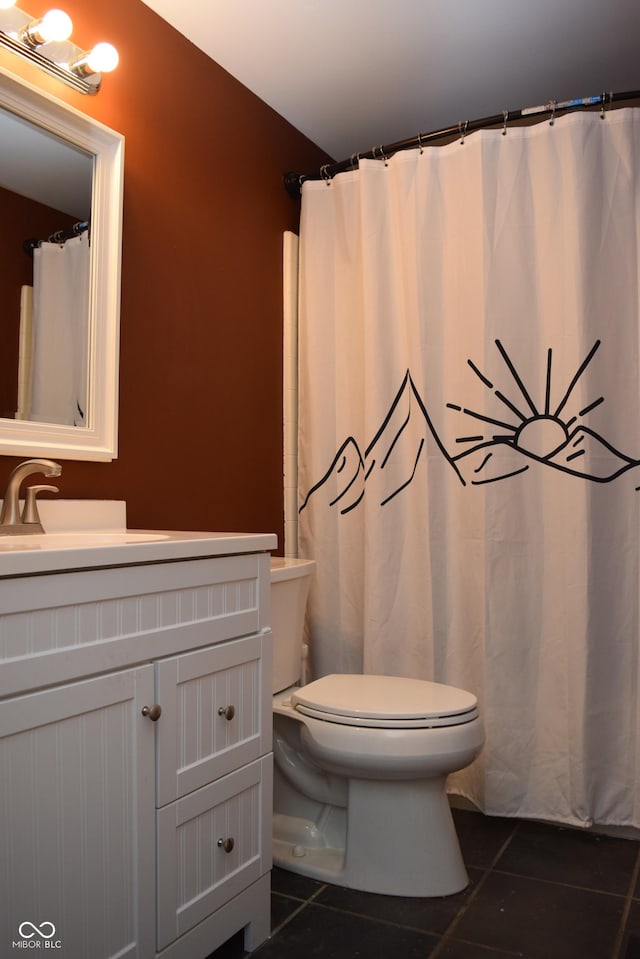 bathroom with toilet, tile patterned floors, and vanity