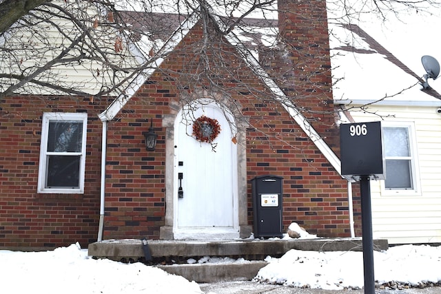 view of snow covered property entrance