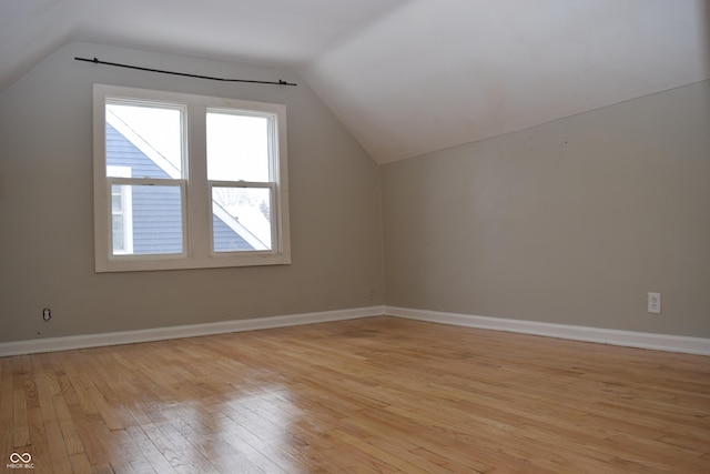 bonus room with light hardwood / wood-style floors and vaulted ceiling