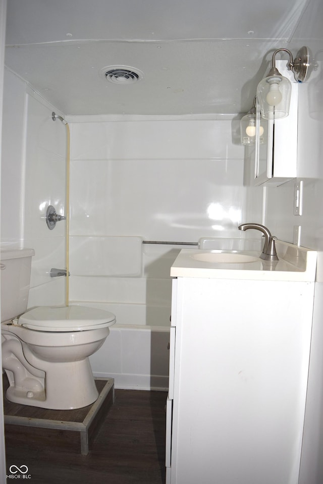 full bathroom featuring shower / bathtub combination, hardwood / wood-style flooring, vanity, and toilet