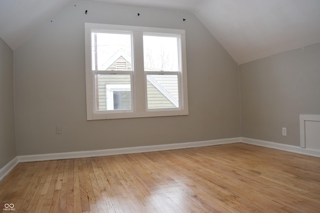 bonus room featuring lofted ceiling and light hardwood / wood-style flooring