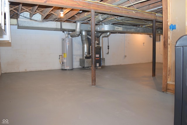 basement featuring gas water heater and heating unit