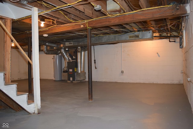 basement featuring water heater and heating unit