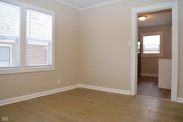 unfurnished room featuring ornamental molding and hardwood / wood-style floors